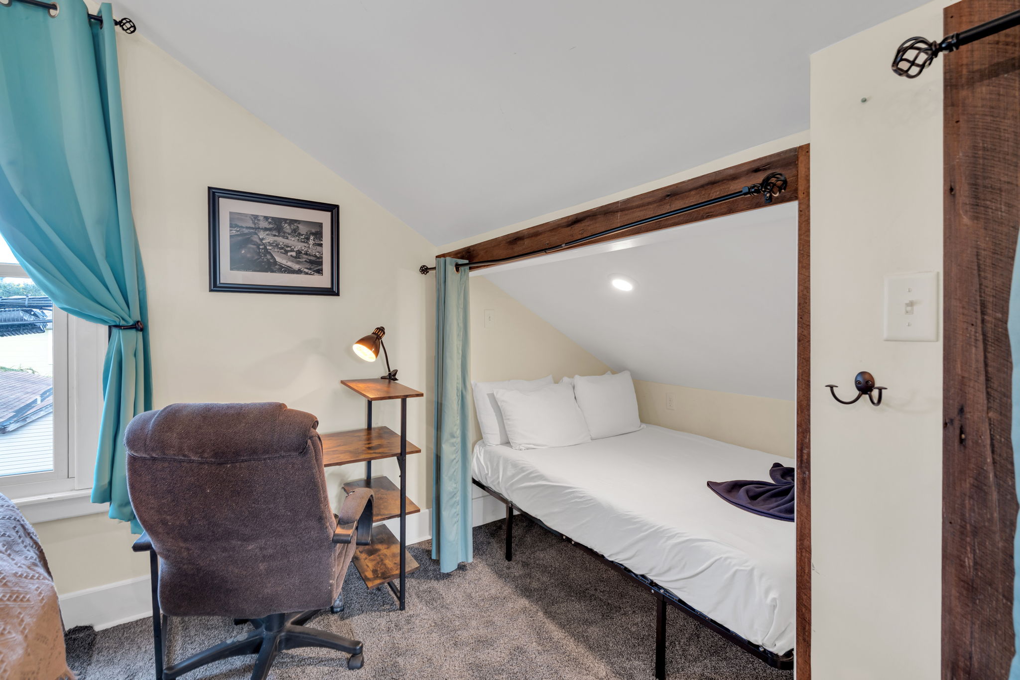 Private loft nook with comfortable bed and reading lamp