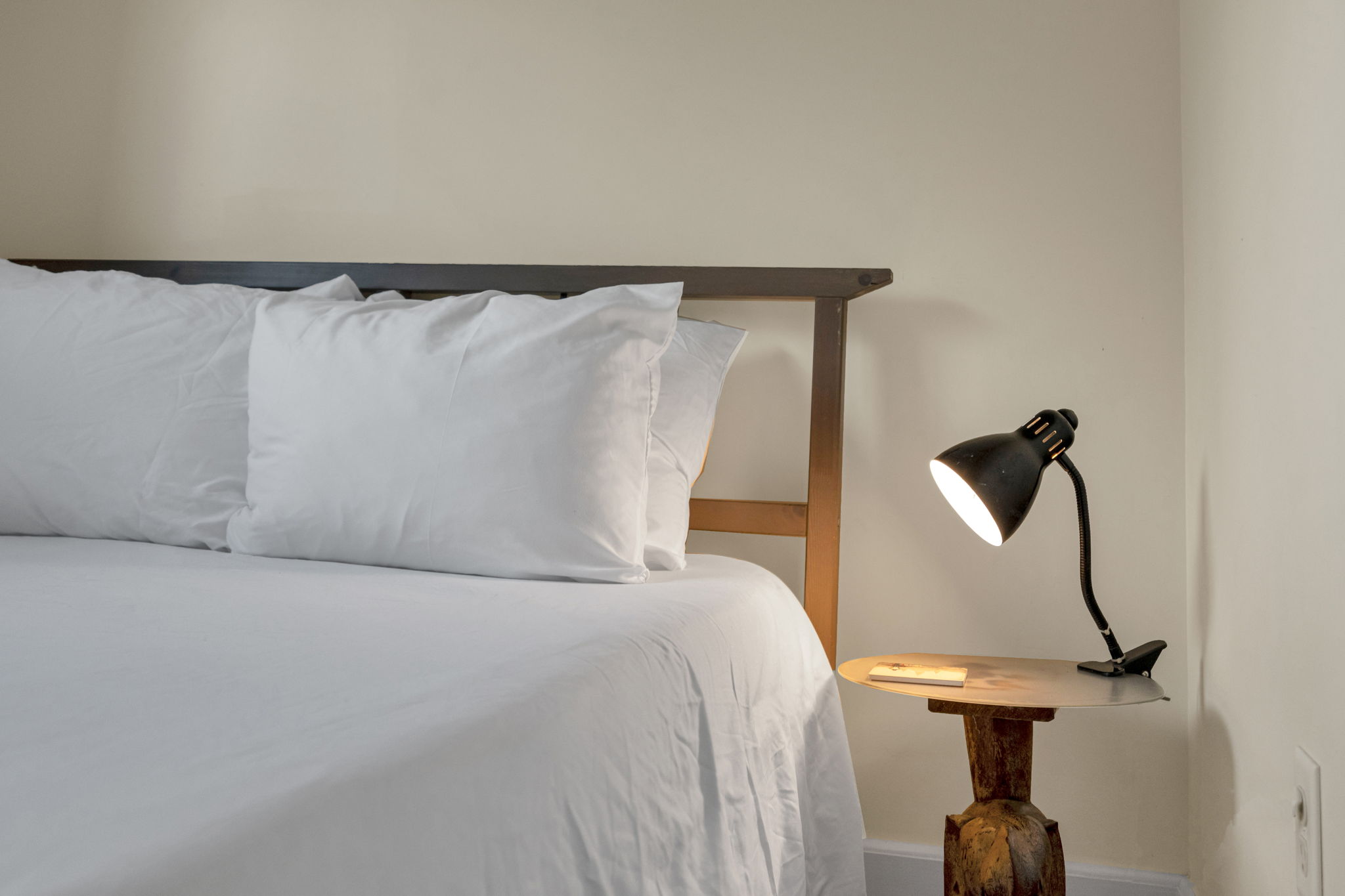 Bedroom-2: Cozy queen suite with warm lighting and soft linens