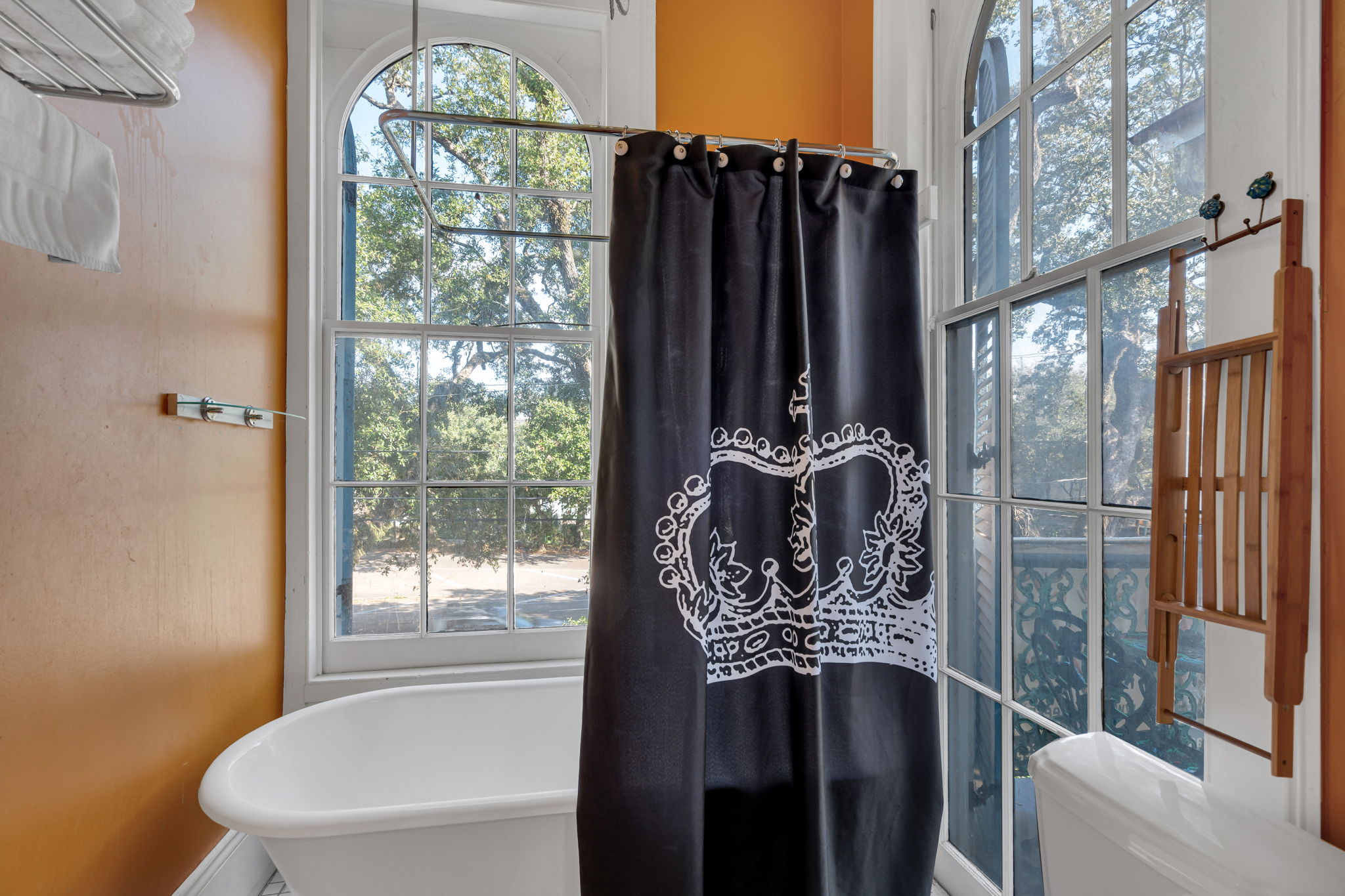 Relaxing clawfoot tub in a historic-chic bath with beautiful arched windows