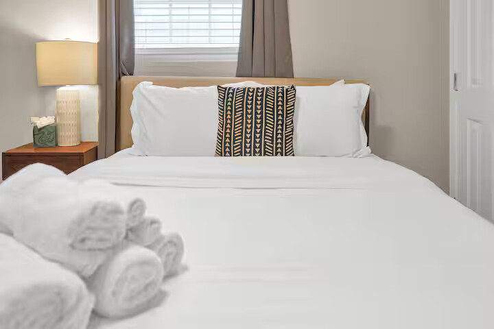 Bedroom 1 features a cozy bed, soft linens, and warm lighting.