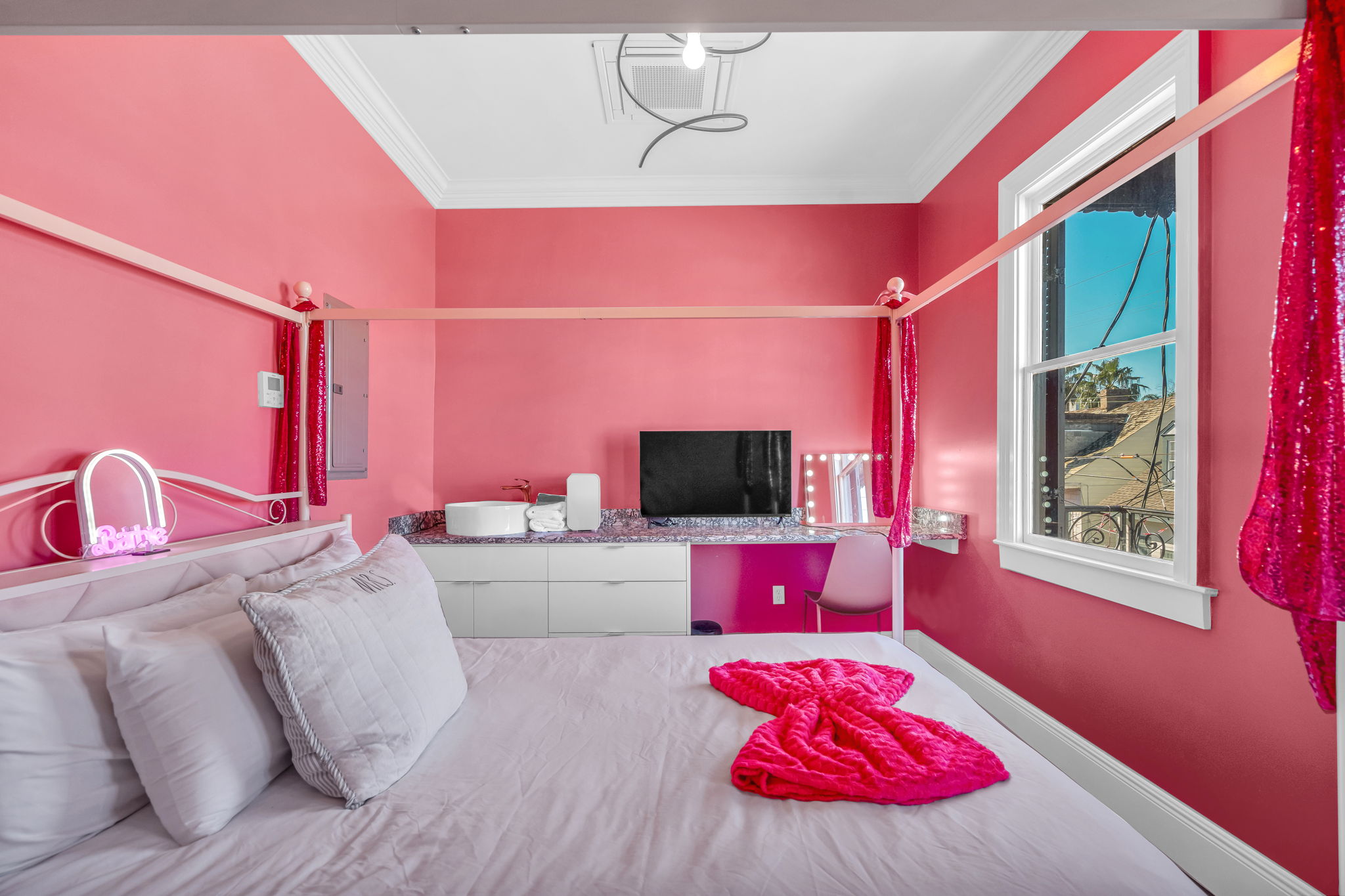 Pink bedroom with TV and style