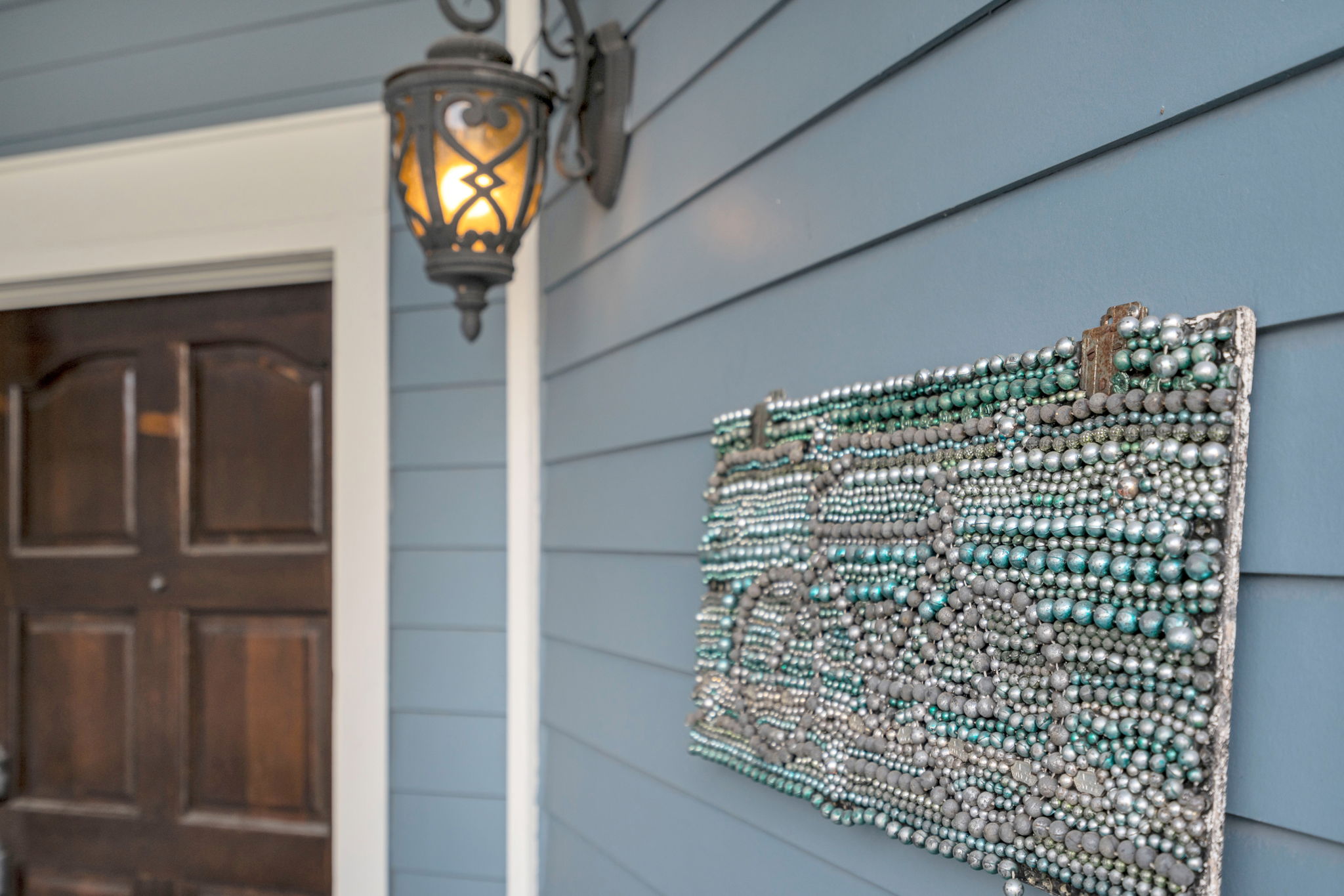 Welcoming porch with lantern lighting and local flair.