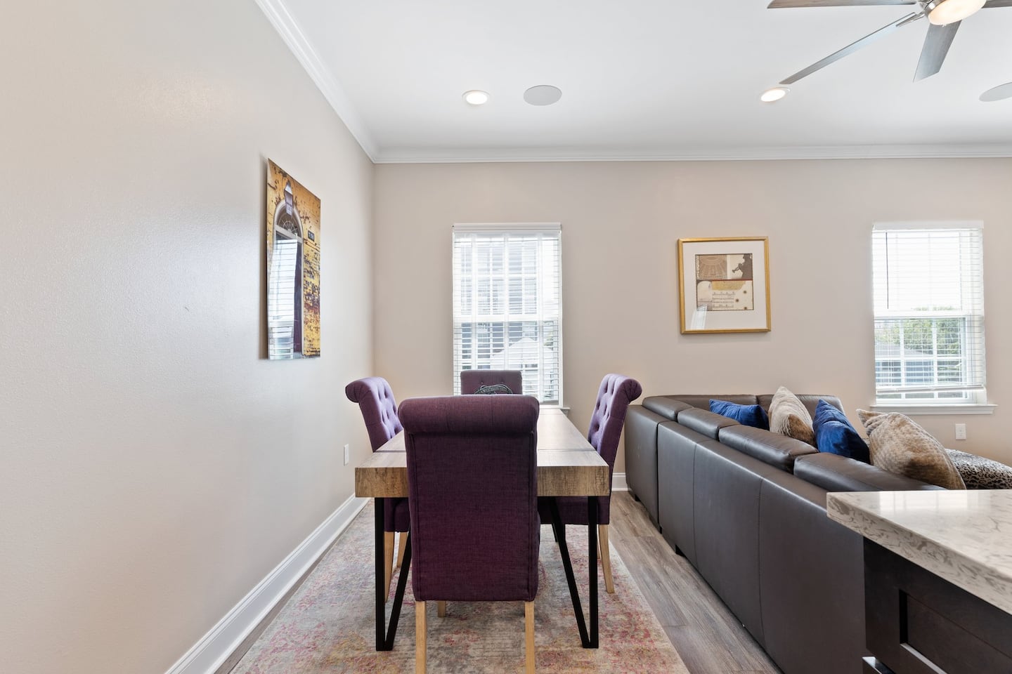 Dining table located behind couch in living room | four seats