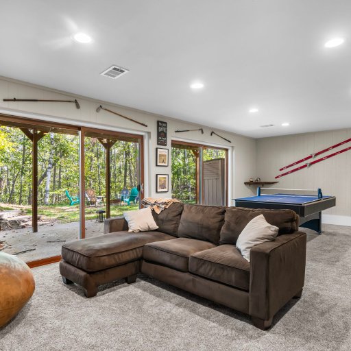 Lower-level walkout with pool table, smart TV, and a cozy sectional — perfect for après-ski or late-night hangouts.