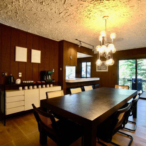 Dining table seats 8 under elegant chandelier