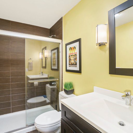 Modern primary bathroom featuring a walk-in shower, fresh towels, and thoughtful amenities