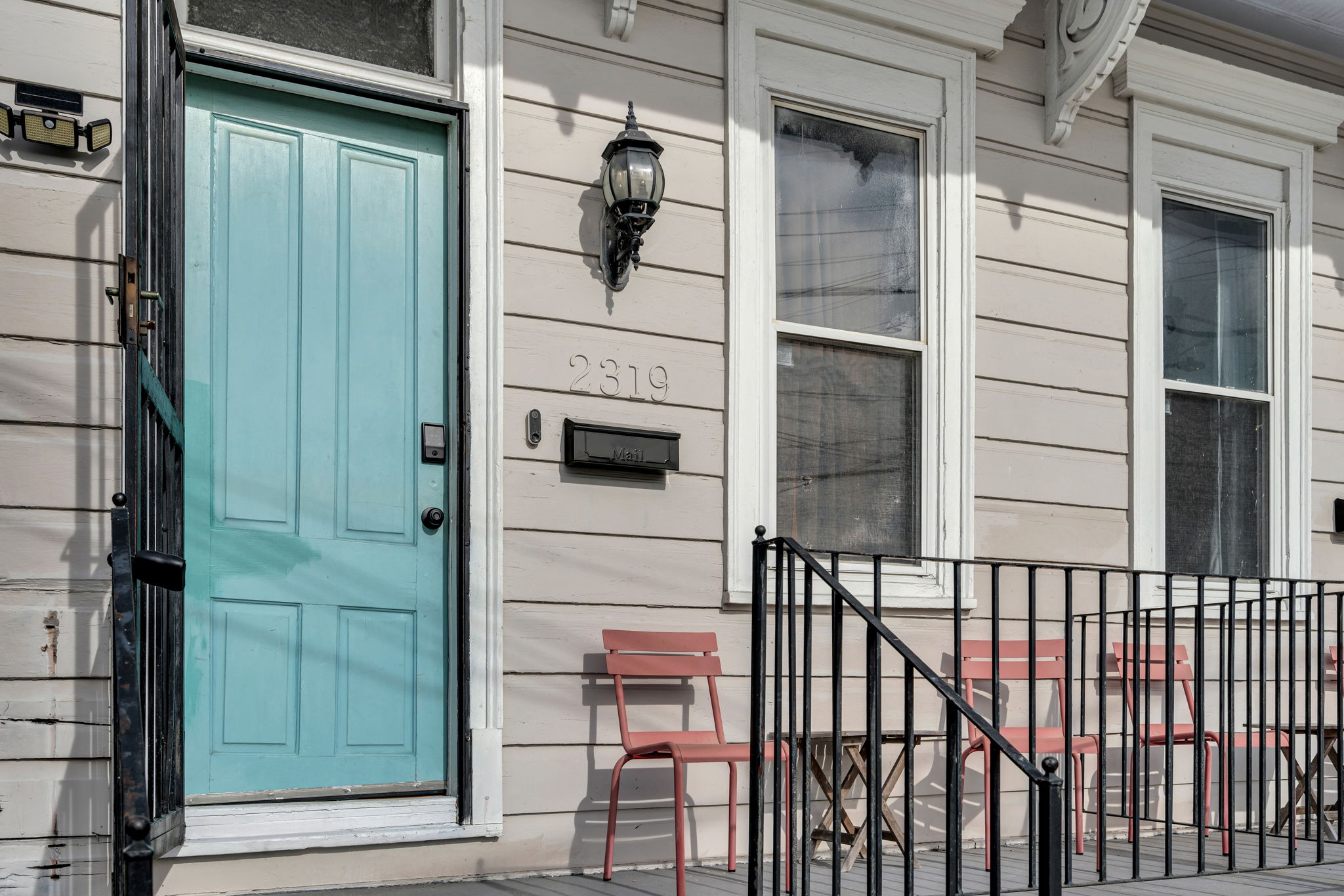 Classic New Orleans entry with teal door