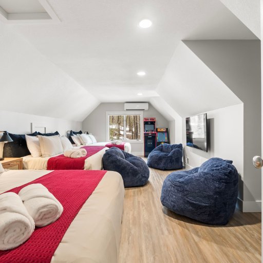 The Crew Room — three full beds, arcade machines, and bean bag lounge