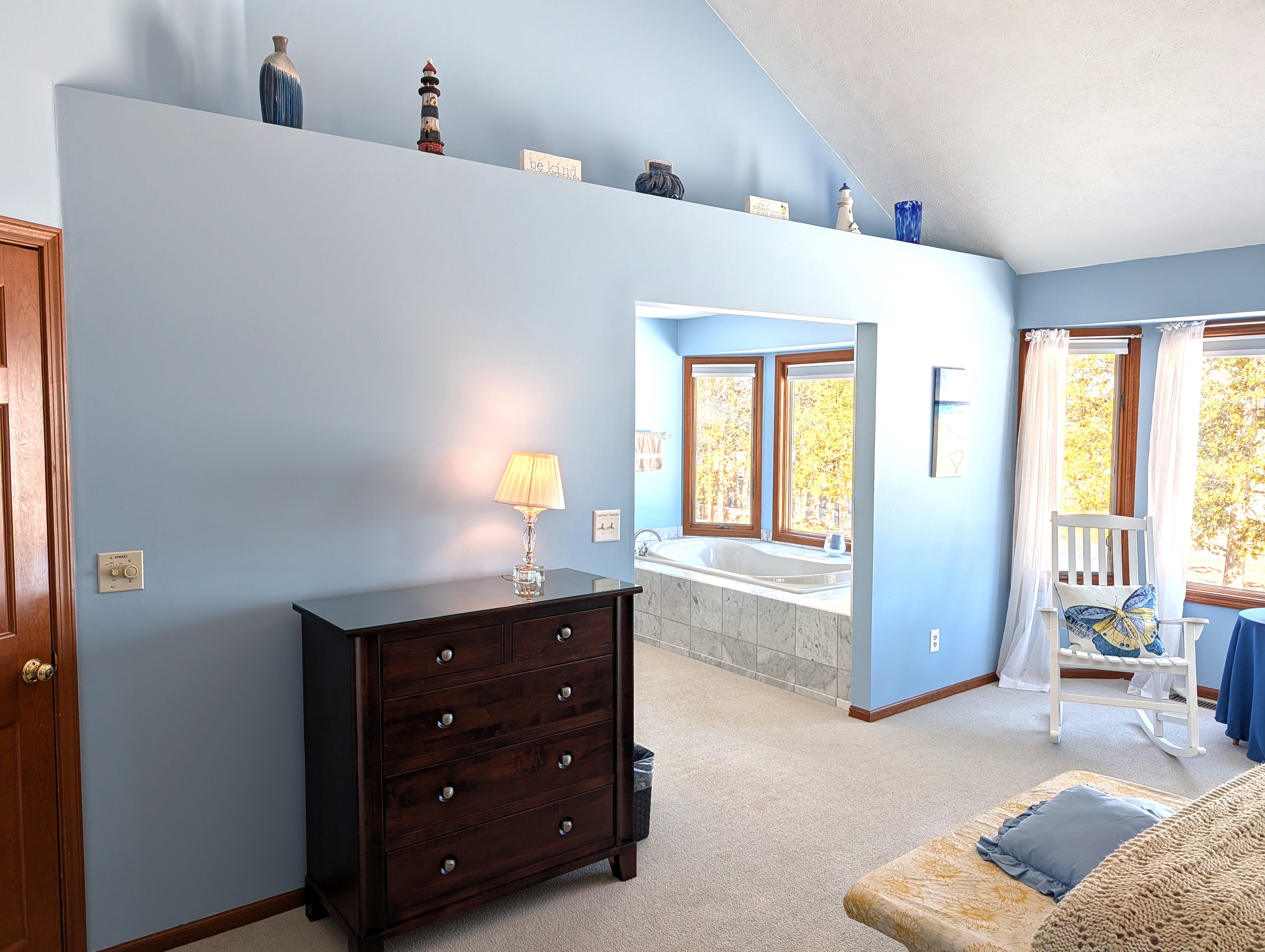 BEDROOM #2 (SECOND FLOOR):  The home has a huge primary bedroom on the second floor with a queen-size bed, private ensuite bathroom, and great views of Big Platte Lake!
