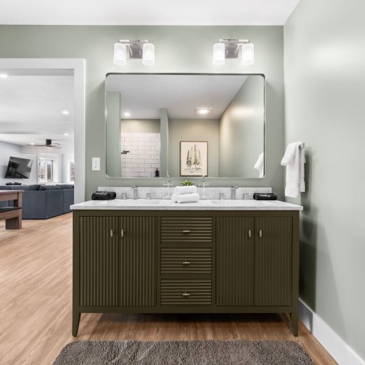 En-suite bath with double vanity and marble countertop