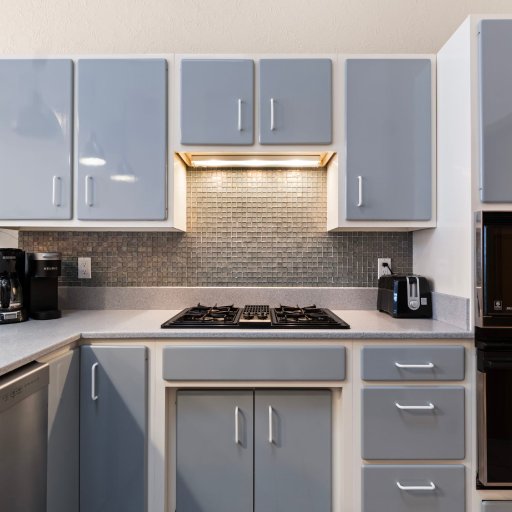 Gas cooktop, wall oven, and microwave with counter space either side.