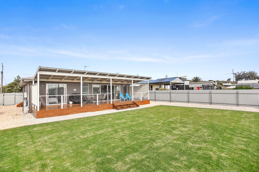 Fully furnished covered deck with BBQ and outdoor furniture, plus a fully fenced rear yard perfect for children.