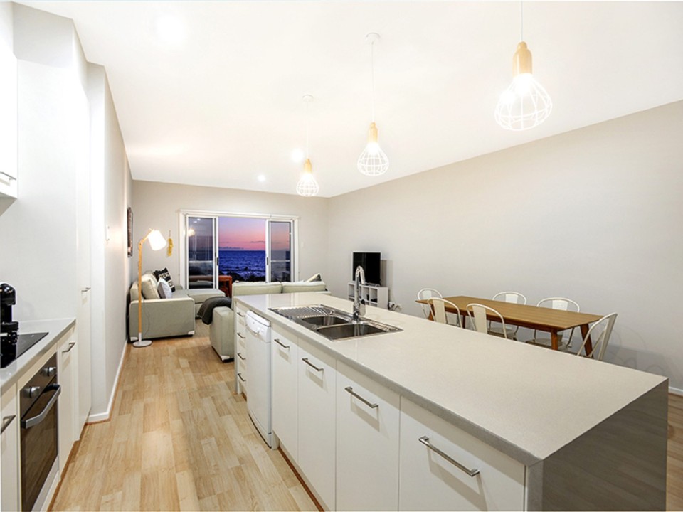 Features a fully equipped kitchen and a shaded rear BBQ area for alfresco dining, ensuring convenience and comfort for extended stays.