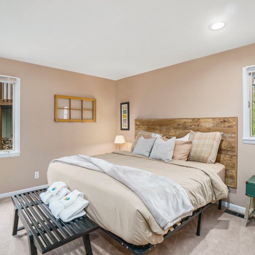 Spacious primary bedroom with a comfortable queen bed, fresh linens, and a bright, welcoming atmosphere