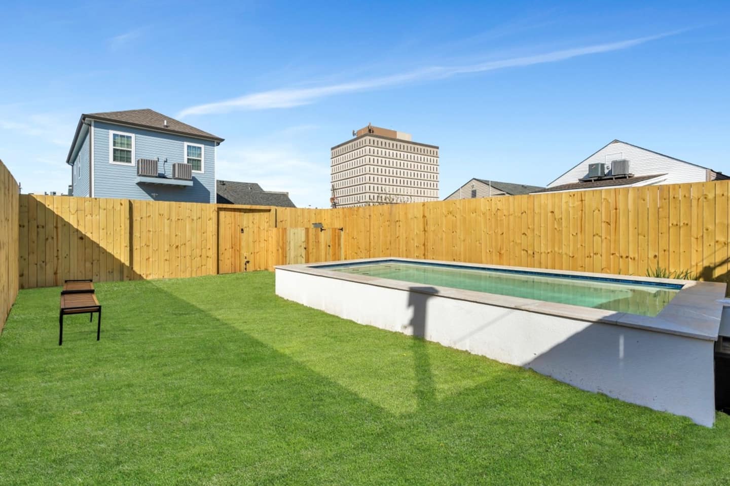 Fully-Fenced Pool with pool toys, towels, and lounge chairs