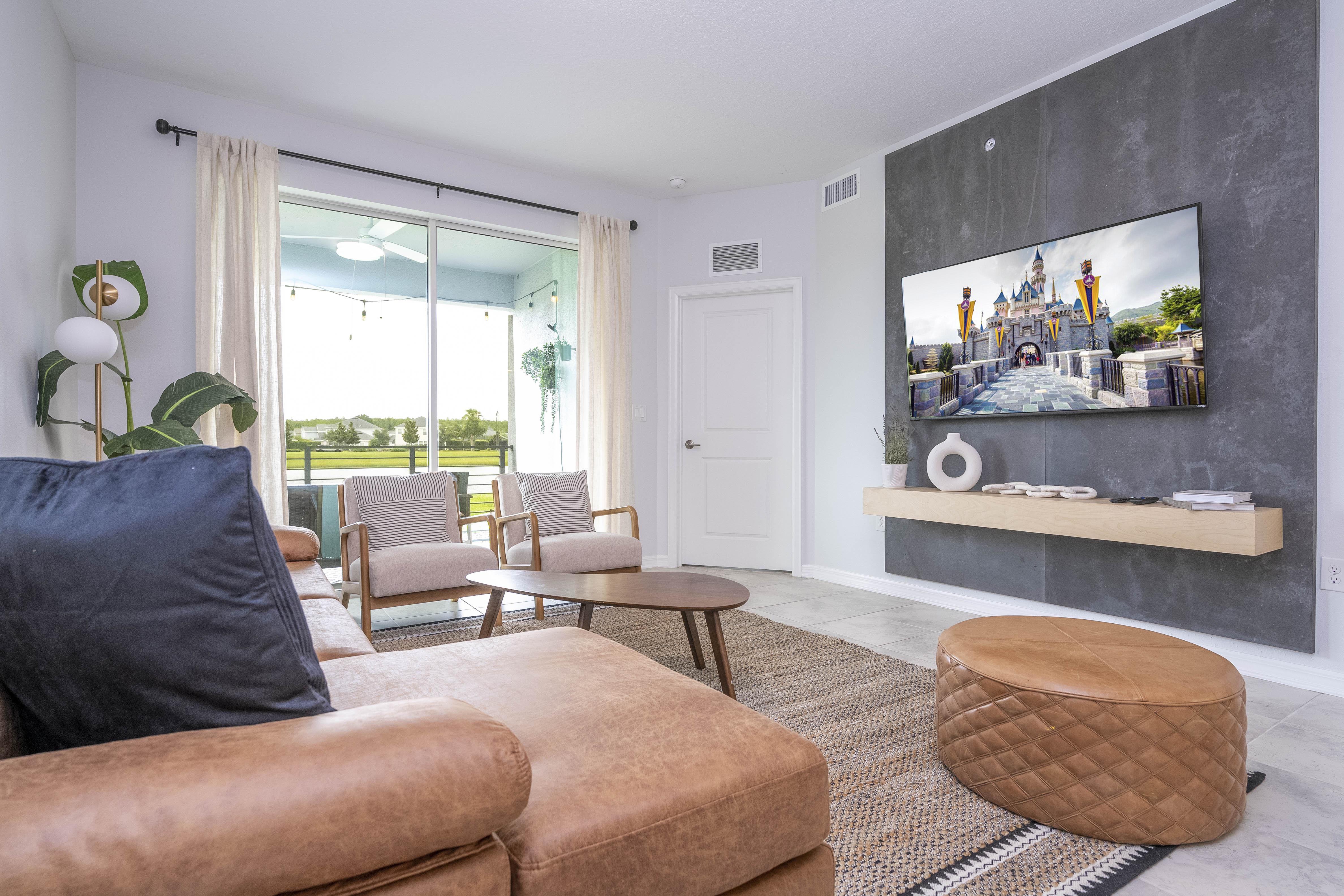 Step into this spacious, comfortable living area. The expansive room is adorned with tasteful decor, offering a blend of modern aesthetics and homey warmth. 