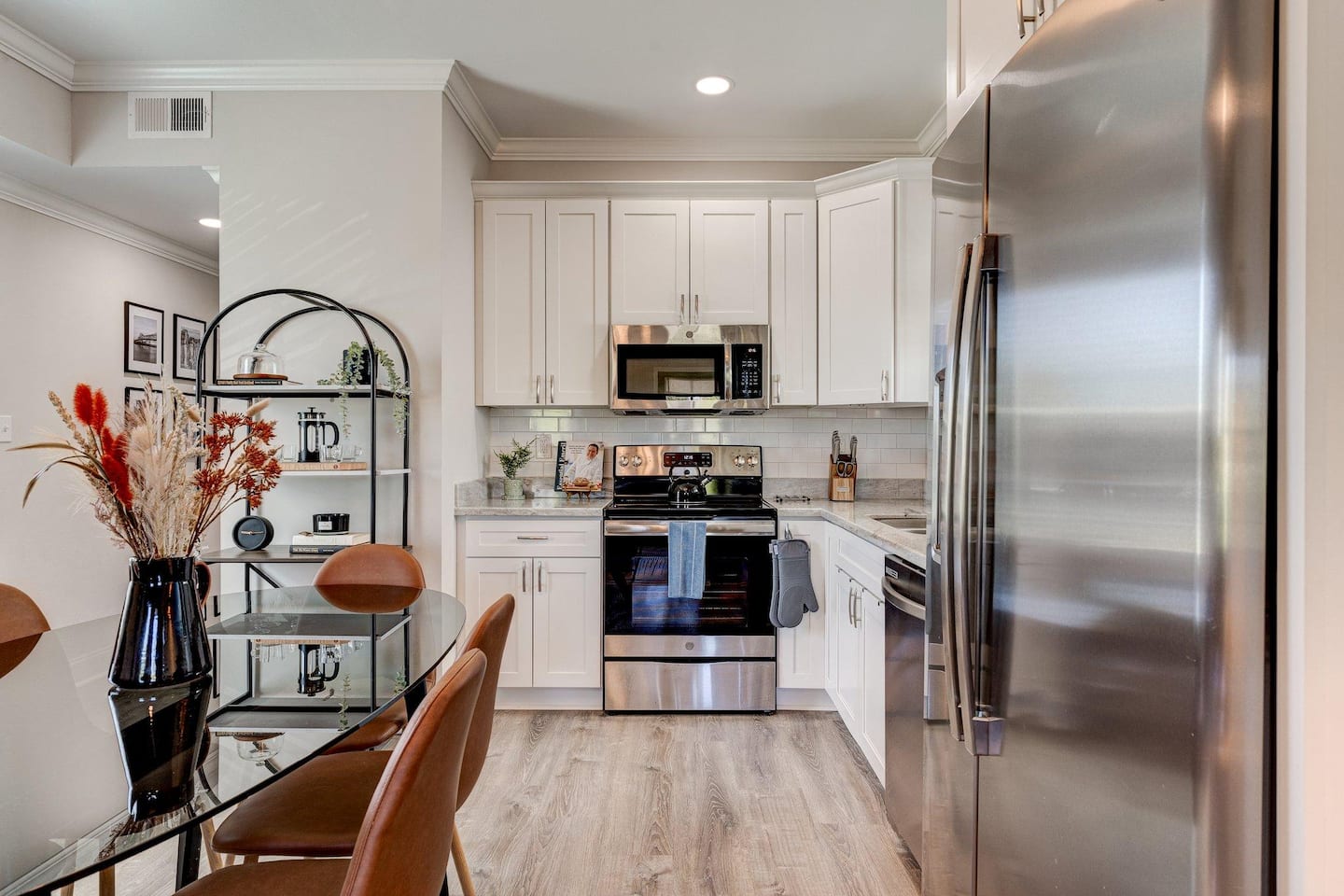 Fully equipped kitchen with stainless steel appliances, modern finishes, and all the essentials for cooking. The adjacent dining table comfortably seats six, making it perfect for shared meals or gatherings.
