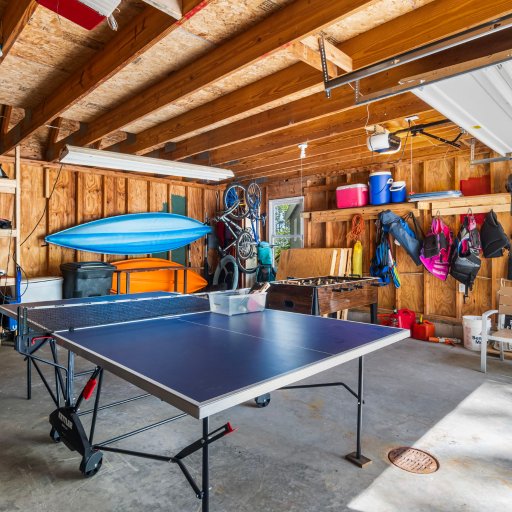 Garage rec space — ping pong, foosball, and kayaks, bikes and life jackets on site.