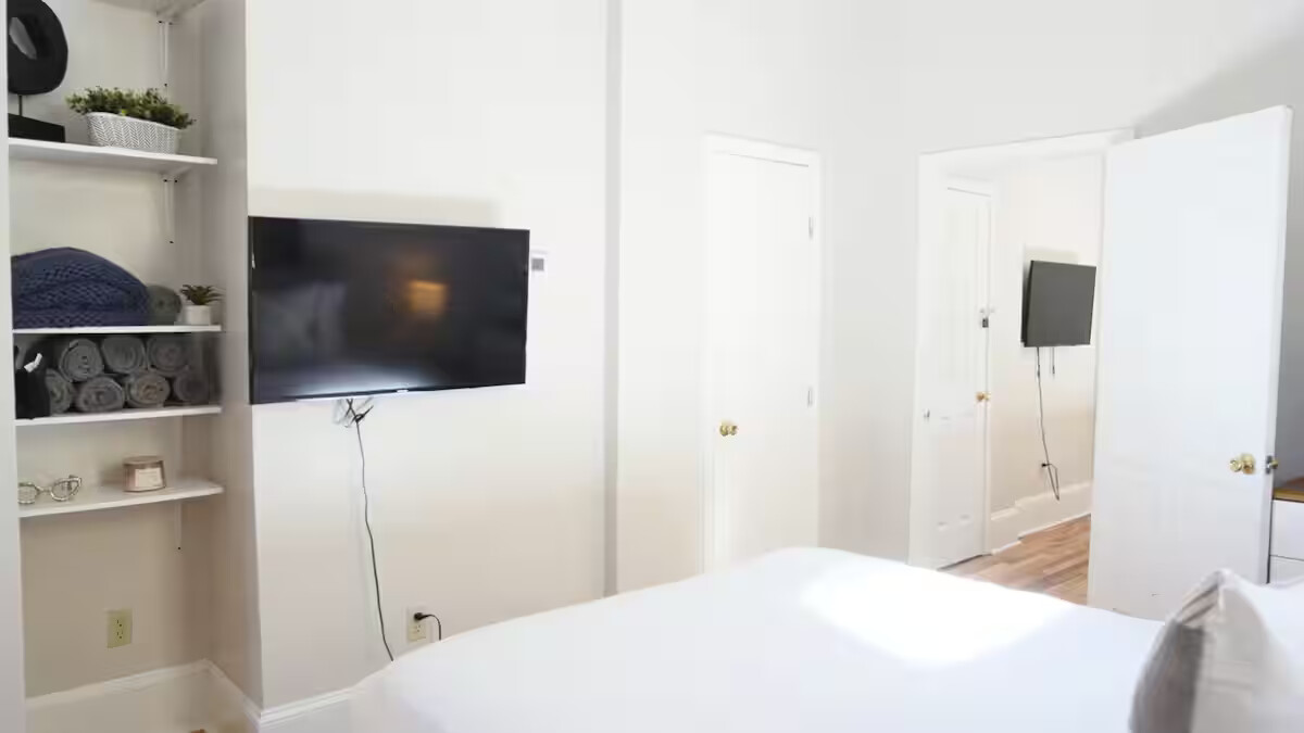 This bedroom combines comfort and convenience with a plush bed, fresh linens, and a smart TV, perfect for relaxing with your favourite shows after a day out.