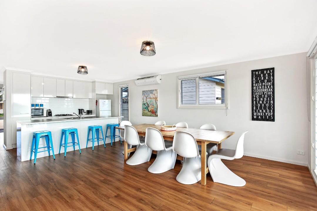 Large open kitchen, dining, and living area with seamless indoor-outdoor flow to the covered deck enhances the holiday lifestyle.