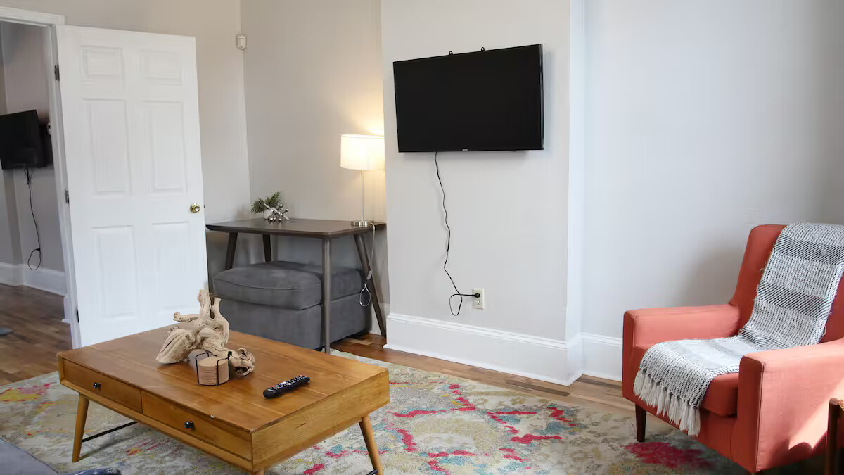 Living room with ample lighting and a smart TV.