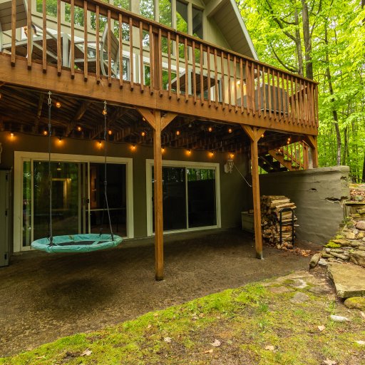 Cozy lower patio area with seating and string lights—ideal for evening relaxation and outdoor fun