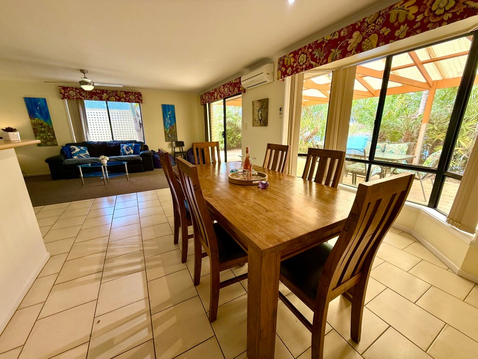 A dining area that comfortably seats six is perfect for shared meals. Please note that the sofa has been replaced with a new one. 