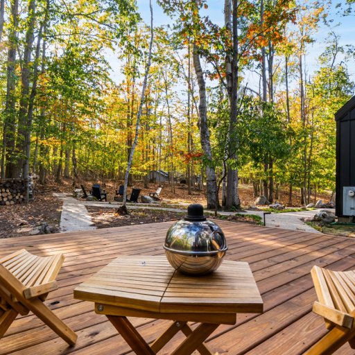 Fire pit with deck seating and forest ambiance