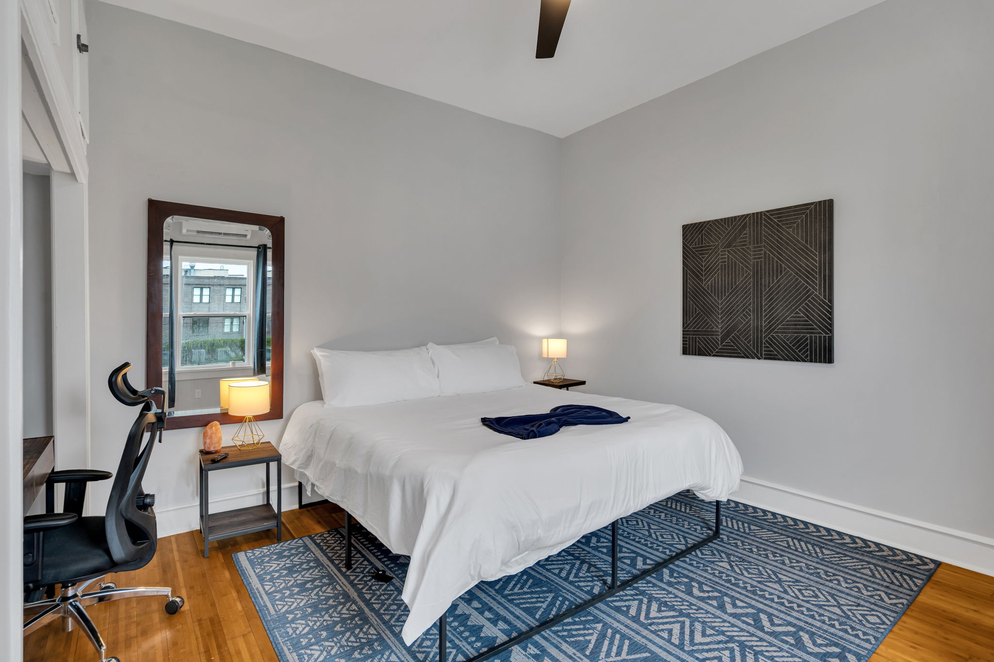 Spacious bedroom with king bed, desk, and relaxing ambiance.