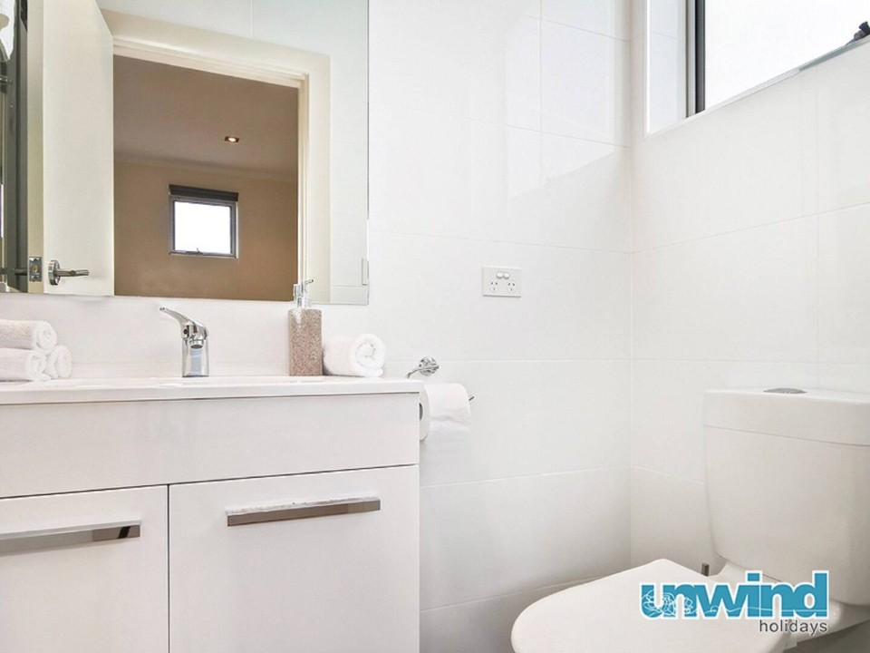 Second bathroom/laundry combo downstairs – includes a shower, additional toilet, and laundry facilities