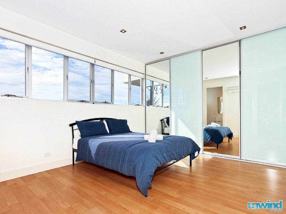 Three large bedrooms configured as two queen beds and two bunk beds, providing comfortable sleeping arrangements.