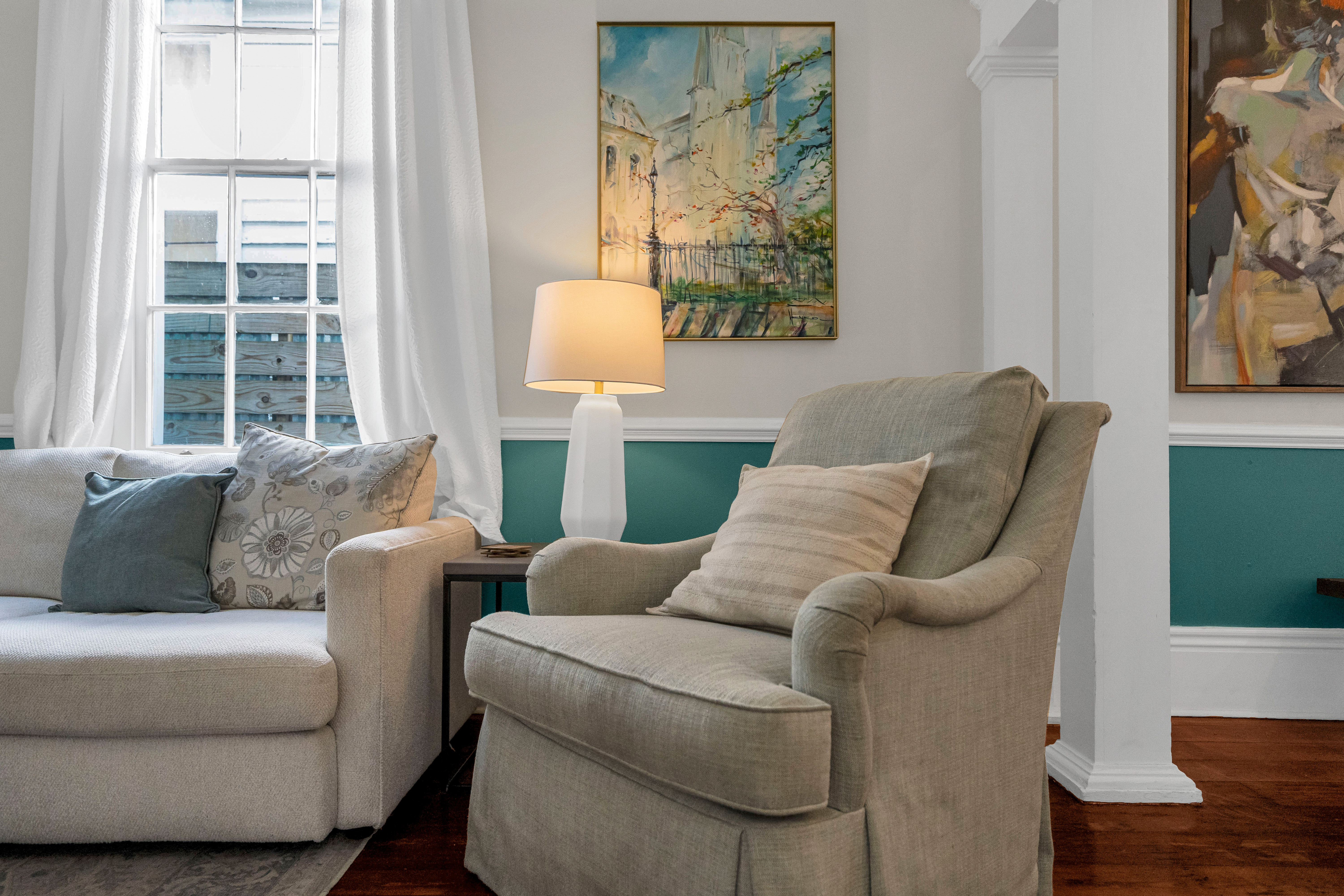 Cozy reading nook with natural light and a comfy chair.
