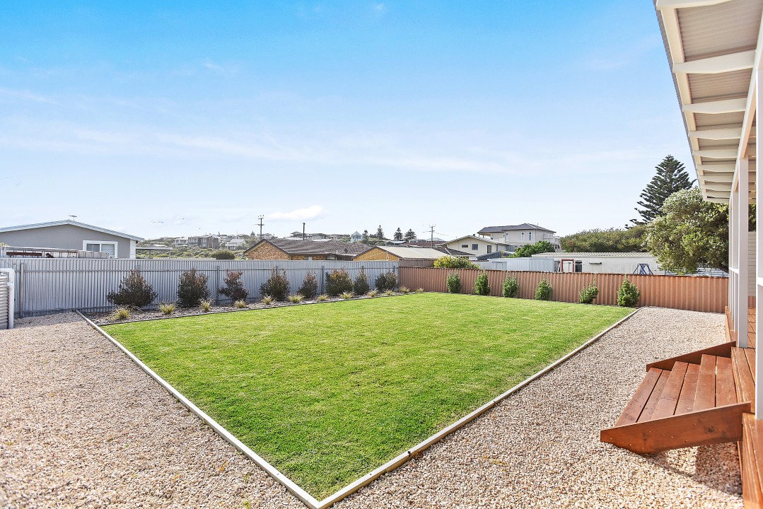 Expansive covered back deck offers uninterrupted, panoramic views of iconic sand dunes, creating a stunning natural backdrop.