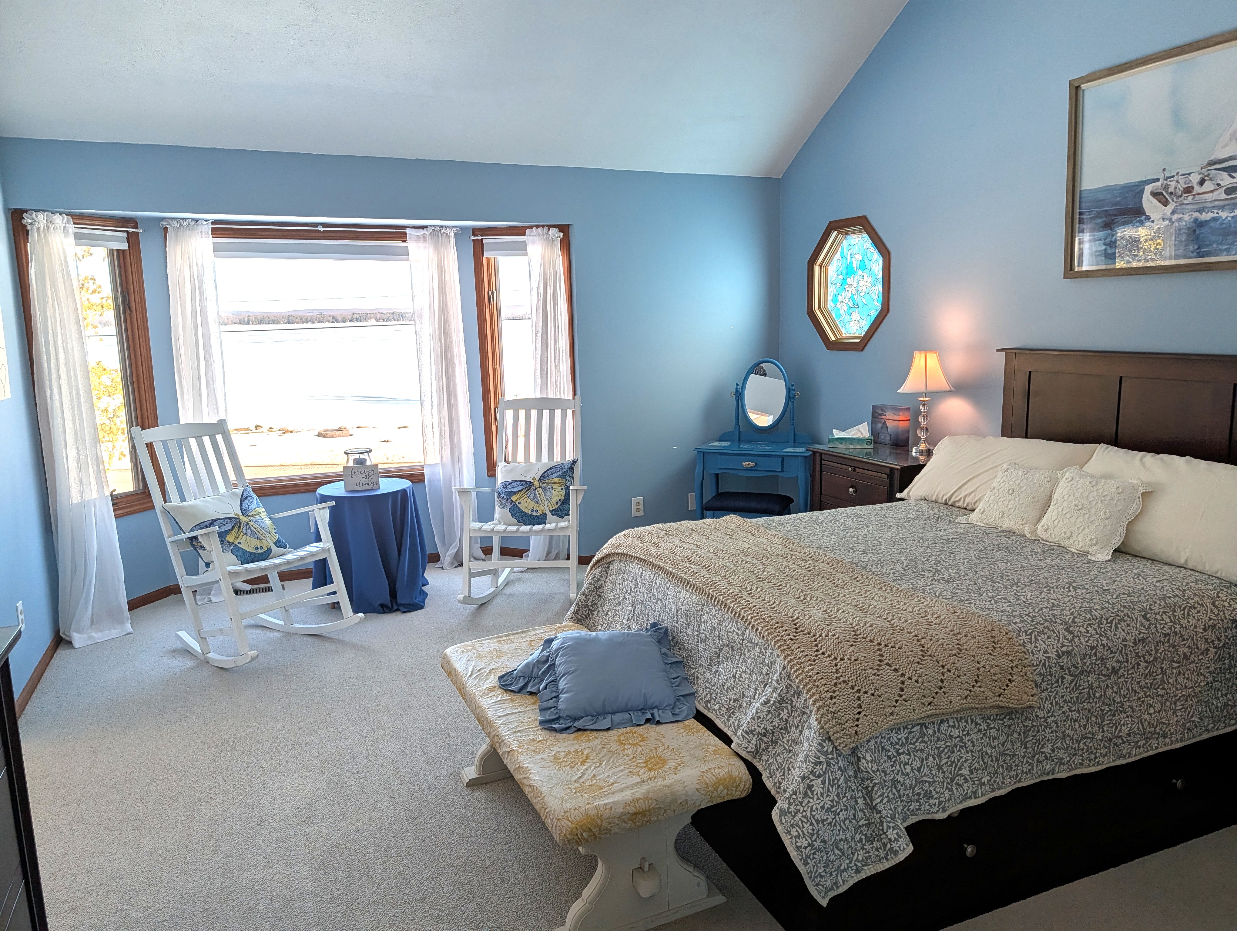 BEDROOM #2 (SECOND FLOOR):  The home has a huge primary bedroom on the second floor with a queen-size bed, private ensuite bathroom, and great views of Big Platte Lake!