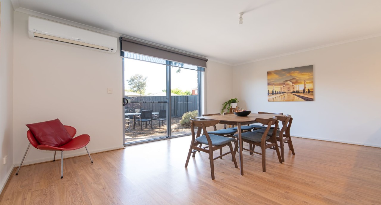 Open-plan layout includes a brand-new wooden dining table that comfortably seats six — perfect for meals and entertaining.