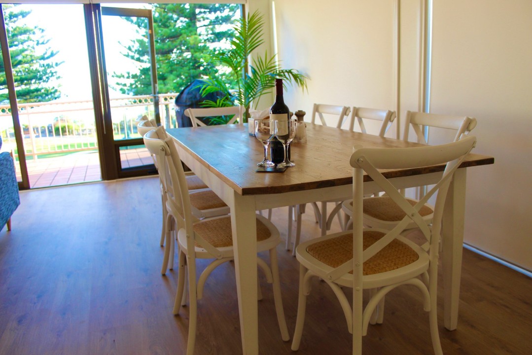 Wake up to stunning views of Victor Harbor’s coastline right from your balcony. (Wine pictured is for styling purposes only.)