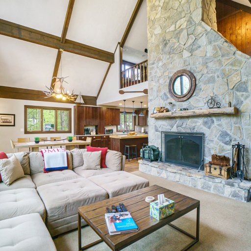 Cozy up in the living room with vaulted ceilings, a stone fireplace, and plenty of seating for your group.