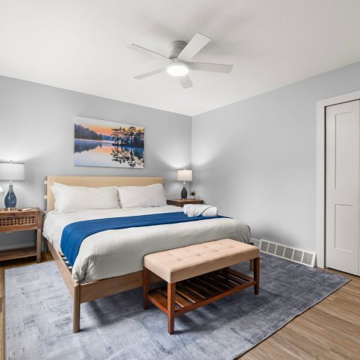 Bedroom 2 — King bed with ceiling fan and lake art