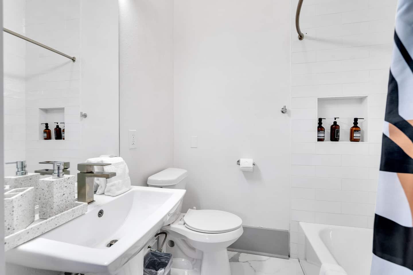 Relax and refresh in this bright, spa-like bathroom featuring elegant fixtures, a deep soaking tub, and premium toiletries. Thoughtfully designed for comfort and style, it's the perfect place to unwind after a long day.