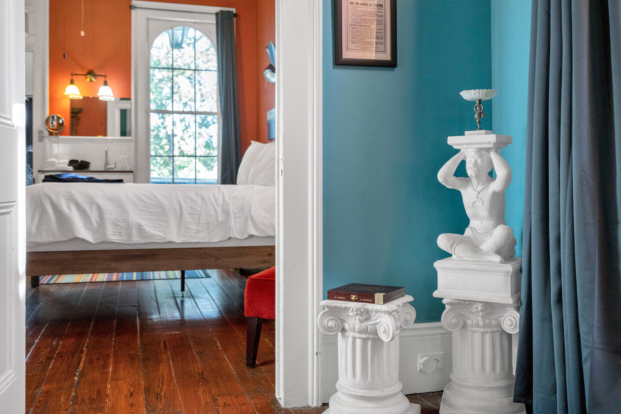 Unique Atlas statue candle holder on a classic Ionic column pedestal.