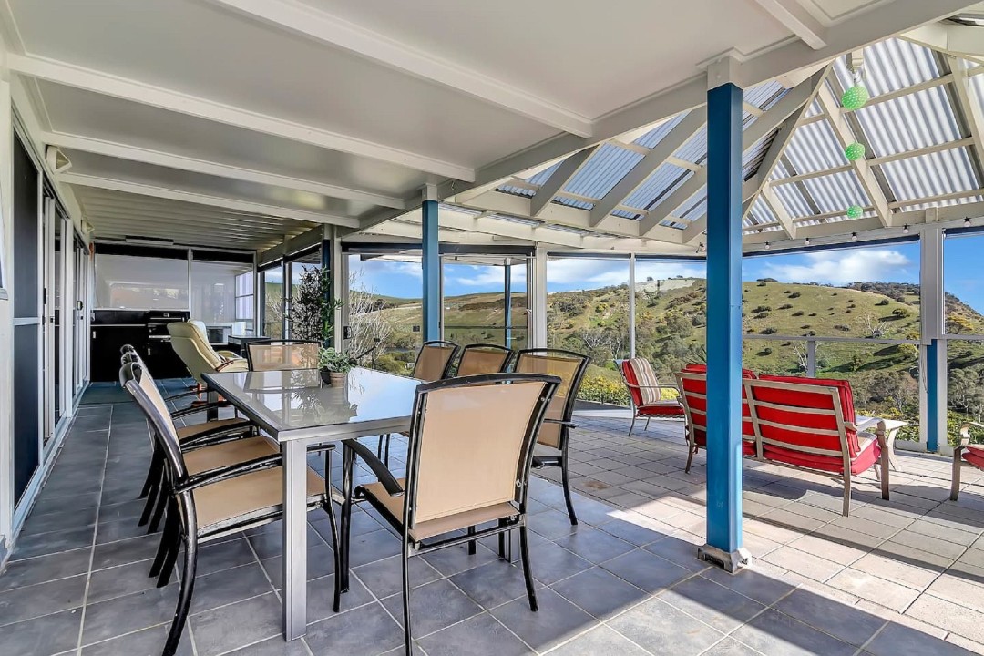 The upper-level loft features a private balcony and sink, perfect for peaceful reflection or morning coffee with a view.