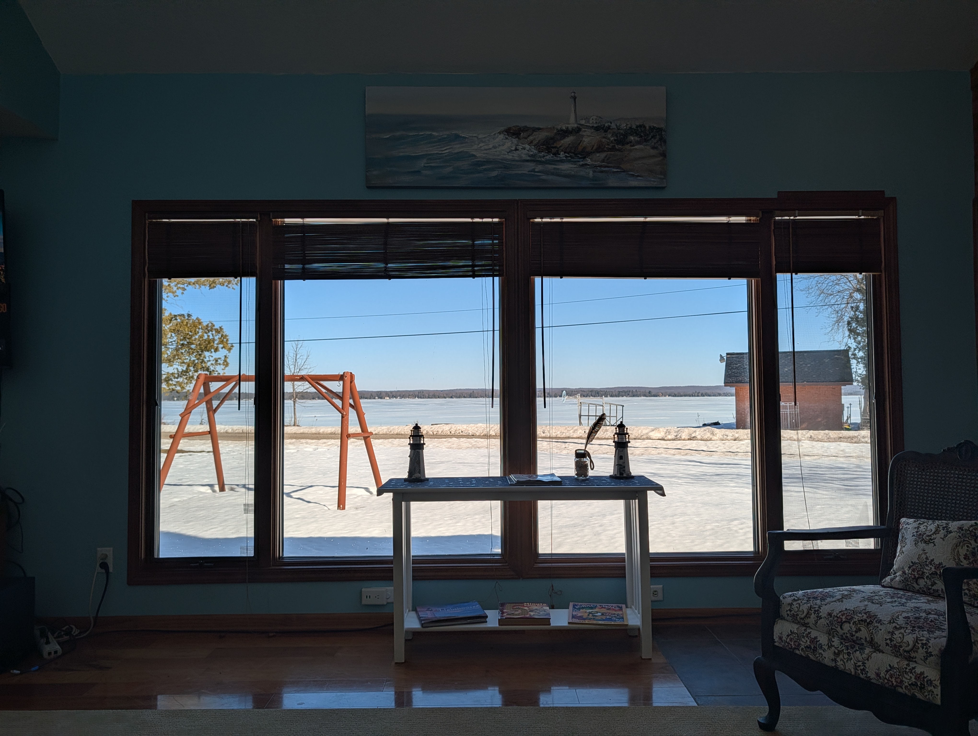 LIVING ROOM #1:  The primary living room, which has a great view of Big Platte Lake!  (Note that the wood fireplace in the photo is available for guest usage.)