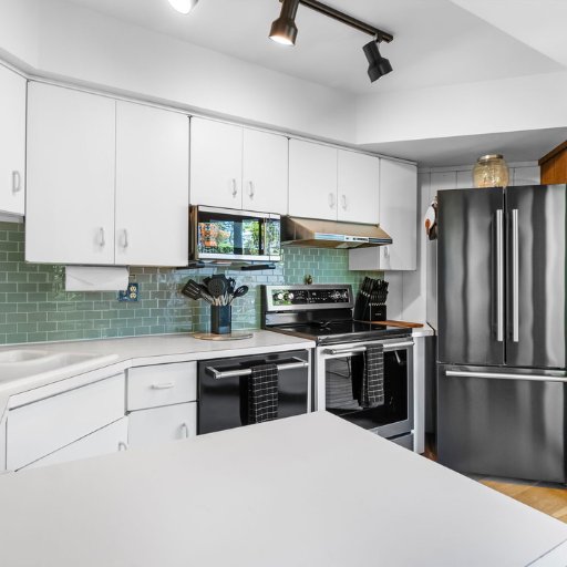 Bright modern kitchen with stainless appliances and storage