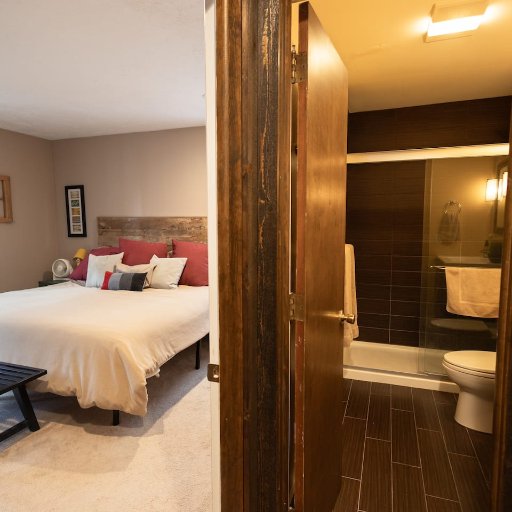 Rest easy in the primary bedroom featuring a plush bed, warm decor, and a peaceful vibe for a great night's sleep.