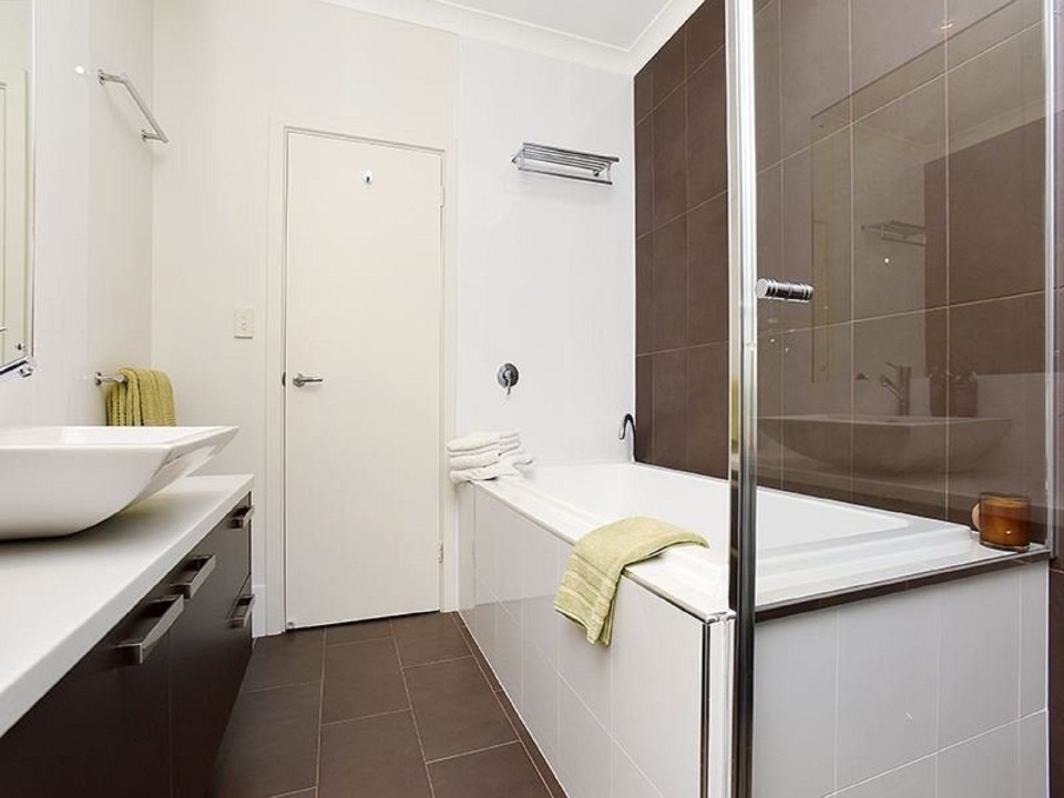 Premium Bathrooms. Ensuite with double vanities and rainfall shower, main bath with soaking tub and floor-to-ceiling tiles. Additional powder room/toilet for guests’ convenience