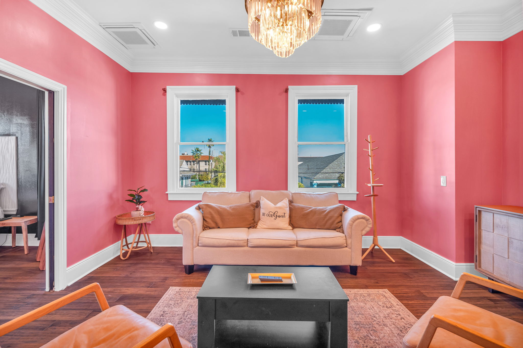 Sunlit lounge framed by vibrant pink walls