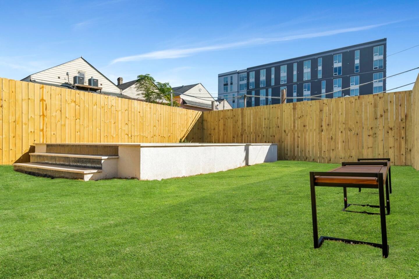 Fully-Fenced Pool with pool toys, towels, and lounge chairs