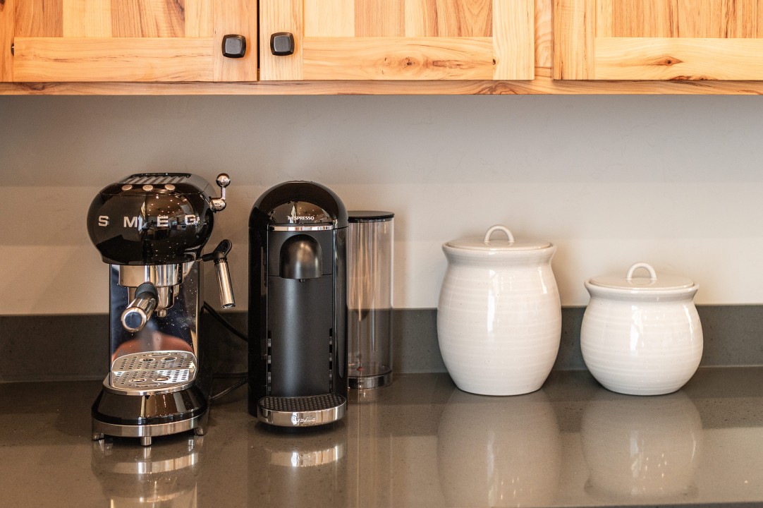 Coffee station features a Smeg espresso machine with bean grinder ...