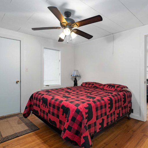 Bedroom 2 — Queen bed with dresser and ceiling fan