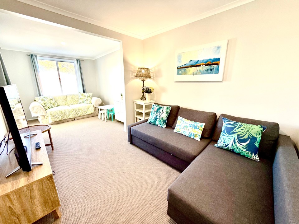 Flexible four-bedroom layout, including a second living area with a sofa bed and deck access